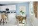 Kitchen features white cabinets, granite countertops, and a breakfast nook at 2288 Sirena Ln, Mount Dora, FL 32757
