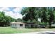 Single-story home with large yard and trees at 1050 S Main Ave, Groveland, FL 34736