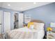 Spacious bedroom with queen bed, neutral decor, and ensuite bathroom access at 143 Bob Thomas Cir, Sanford, FL 32771