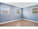 Empty bedroom with light blue walls and wood-look floors at 143 Bob Thomas Cir, Sanford, FL 32771