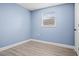 Simple bedroom with light walls and wood-look flooring at 143 Bob Thomas Cir, Sanford, FL 32771