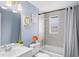 Updated bathroom with tub, gray tile, and a white vanity at 143 Bob Thomas Cir, Sanford, FL 32771