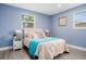 Bright bedroom with light beige bedding and wood-look floors at 143 Bob Thomas Cir, Sanford, FL 32771
