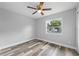 Simple bedroom with wood flooring and a window at 274 N Ranger Blvd, Winter Park, FL 32792