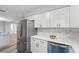 White kitchen features stainless steel appliances and marble backsplash at 274 N Ranger Blvd, Winter Park, FL 32792