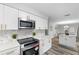 Updated kitchen with stainless steel appliances and white cabinetry at 274 N Ranger Blvd, Winter Park, FL 32792
