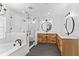 Modern bathroom with white subway tile, freestanding tub, and walk-in shower at 515 N Boyd St, Winter Garden, FL 34787