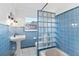 Charming bathroom with blue tile and glass block shower at 515 N Boyd St, Winter Garden, FL 34787