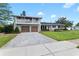 Two-story home with gray siding, two-car garage, and spacious yard at 515 N Boyd St, Winter Garden, FL 34787