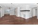 Open concept living room with hardwood floors and a white fireplace at 515 N Boyd St, Winter Garden, FL 34787