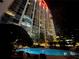 Night view of resort-style pool and building exterior at 155 S Court Ave # 2310, Orlando, FL 32801
