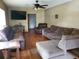 Spacious living room featuring hardwood floors and ample seating at 1050 S Main Ave, Groveland, FL 34736
