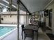 Relaxing poolside patio with seating and covered lanai at 1050 S Main Ave, Groveland, FL 34736