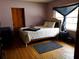 Cozy bedroom with hardwood floors and a window at 1050 S Main Ave, Groveland, FL 34736
