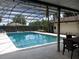 Inviting screened pool area with patio furniture at 1050 S Main Ave, Groveland, FL 34736
