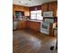Kitchen with wood cabinets, stainless steel appliances, and hardwood floors at 1050 S Main Ave, Groveland, FL 34736
