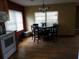 Bright dining area adjacent to the kitchen with hardwood floors at 1050 S Main Ave, Groveland, FL 34736