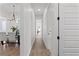 Bright hallway with wood-look tile floors and access to multiple rooms at 3429 Boggy Creek Rd, Kissimmee, FL 34744