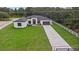 Aerial view of home, showcasing the driveway and yard at 3429 Boggy Creek Rd, Kissimmee, FL 34744