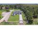 Stunning aerial view of a modern farmhouse with fenced yard at 3429 Boggy Creek Rd, Kissimmee, FL 34744