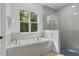 Modern bathroom with soaking tub and walk-in shower at 3429 Boggy Creek Rd, Kissimmee, FL 34744