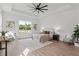 Main bedroom with plush bed, wood-look floors, and large window at 3429 Boggy Creek Rd, Kissimmee, FL 34744