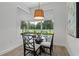 Bright breakfast nook with glass table and view to backyard at 3429 Boggy Creek Rd, Kissimmee, FL 34744