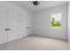 Well-lit bedroom with neutral walls, carpet, and double doors to closets at 3429 Boggy Creek Rd, Kissimmee, FL 34744
