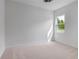 Bright bedroom with carpeted floor, neutral walls, and a window offering natural light at 3429 Boggy Creek Rd, Kissimmee, FL 34744