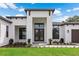 Modern house entrance with double doors and landscaping at 3429 Boggy Creek Rd, Kissimmee, FL 34744