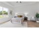 Main bedroom with a plush bed, wood-look floors, and large window at 3429 Boggy Creek Rd, Kissimmee, FL 34744