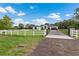 Modern house exterior with a long driveway and fence at 3429 Boggy Creek Rd, Kissimmee, FL 34744