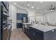 View of kitchen with island, stainless steel appliances, and dark blue cabinetry at 3429 Boggy Creek Rd, Kissimmee, FL 34744