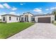 Modern house exterior with green lawn and driveway at 3429 Boggy Creek Rd, Kissimmee, FL 34744