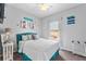 Bright bedroom with a teal headboard and plenty of closet space at 618 Brunello Dr, Davenport, FL 33897