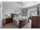Bright bedroom with a queen bed, dark wood furniture, and access to a patio at 618 Brunello Dr, Davenport, FL 33897