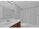 Clean bathroom with updated vanity, shower/tub combo, and neutral colors at 4866 Conway Rd # 116, Orlando, FL 32812