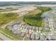 Aerial view of a house in a new development with a lake and conservation area nearby at 4544 White Marble Ct, Lakeland, FL 33811