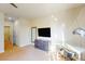 Bright bedroom featuring a dresser, desk, and large TV at 17317 Hidden Forest Dr, Clermont, FL 34714