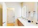 Bathroom with a vanity, illuminated mirror, and Mickey Mouse details at 17317 Hidden Forest Dr, Clermont, FL 34714