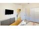 Bedroom with a dresser, large TV and a view of the upstairs hallway at 17317 Hidden Forest Dr, Clermont, FL 34714