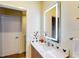 Simple bathroom with lighted mirror and Mickey Mouse decor at 17317 Hidden Forest Dr, Clermont, FL 34714