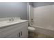 Bathroom with white vanity, quartz countertop, and a shower/tub combo at 106 Cheltenham Pl, Kissimmee, FL 34758