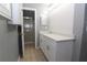 Modern bathroom with white vanity, quartz countertop, and a shower at 106 Cheltenham Pl, Kissimmee, FL 34758