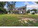Renovated brick home with large windows and landscaping at 1689 Lakeshore Dr, Eustis, FL 32726