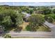 Home situated on corner lot with mature trees and street view at 1689 Lakeshore Dr, Eustis, FL 32726