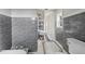 Modern bathroom with gray tile, double sinks, and vintage floor tile at 1689 Lakeshore Dr, Eustis, FL 32726