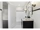 Clean bathroom with white tile, dark vanity and polka dot floor at 1689 Lakeshore Dr, Eustis, FL 32726