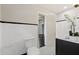 Stylish bathroom with white tile, dark vanity and polka dot floor at 1689 Lakeshore Dr, Eustis, FL 32726