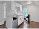 Small galley kitchen with white cabinets and marble countertops at 1689 Lakeshore Dr, Eustis, FL 32726